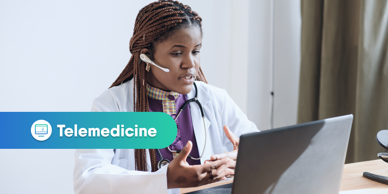 Doctor sitting behind a computer and conducting a telemedicine appointment