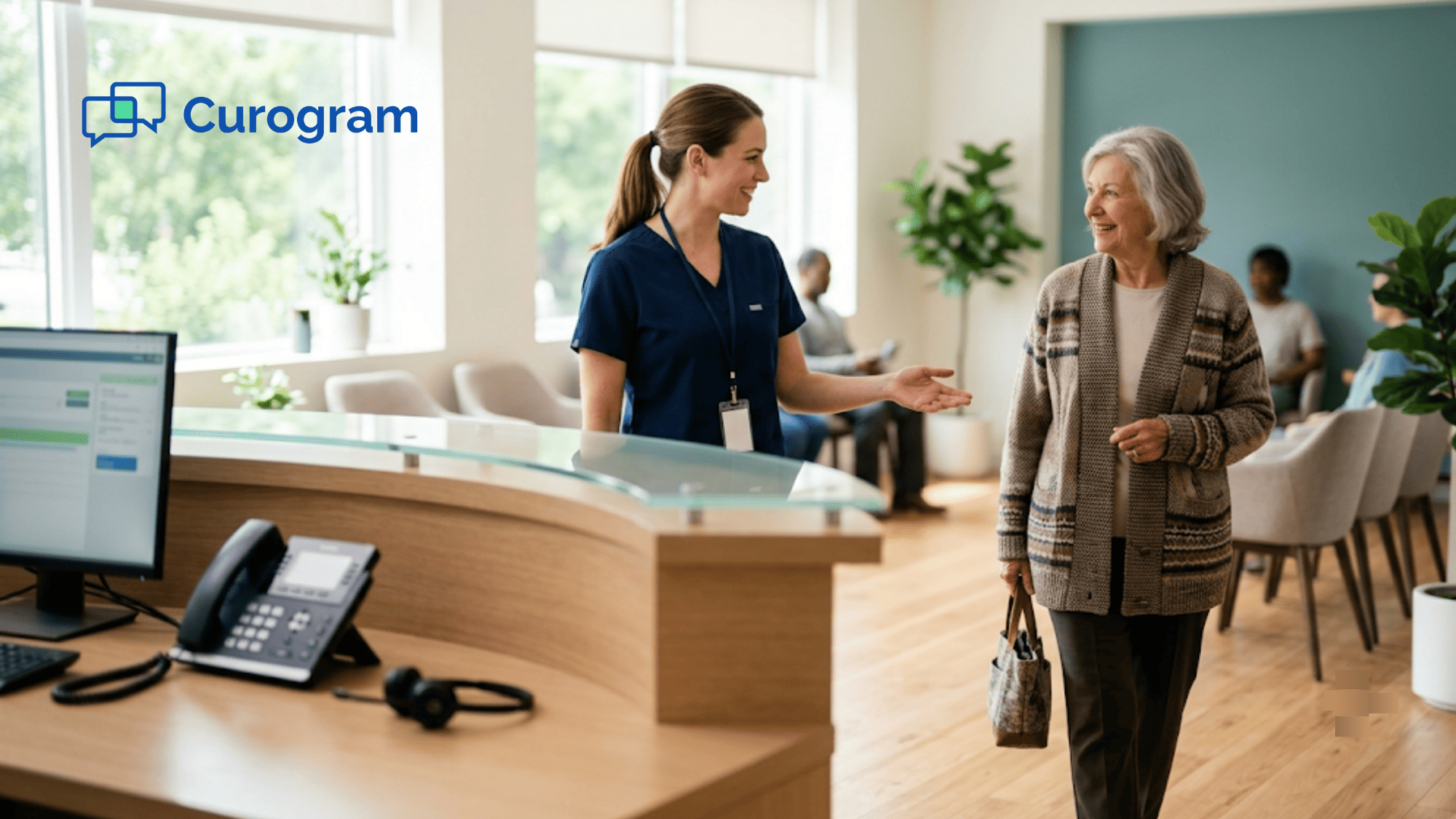 Front-desk receptionist warmly greeting a patient while the phone sits idle nearby