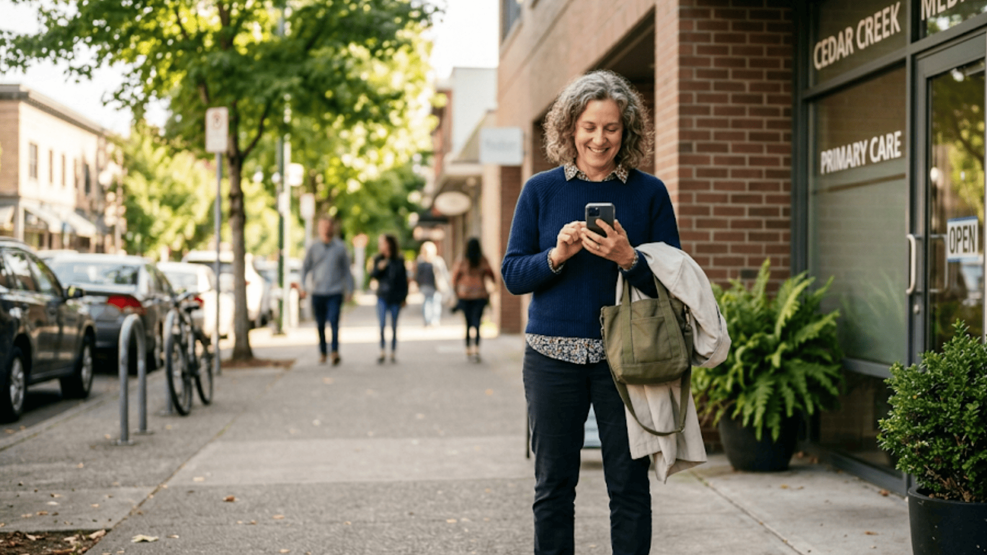 Patient outside a clinic holding a phone moments after a visit