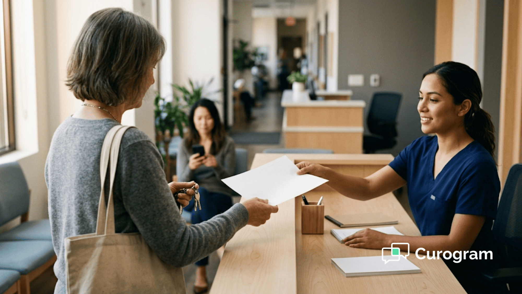 Clinic receptionist hands a patient an after-visit summary at a multi-location medical group checkout counter
