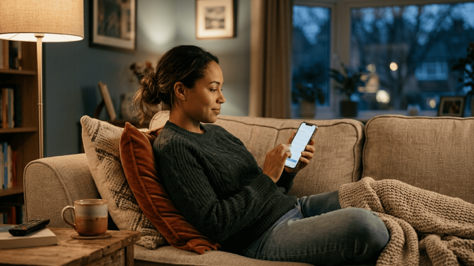 Client comfortably completing behavioral health intake forms on a smartphone at home