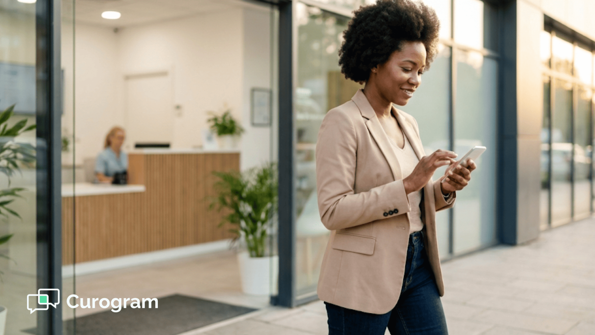 Woman checking her smartphone outside a modern doctor's office