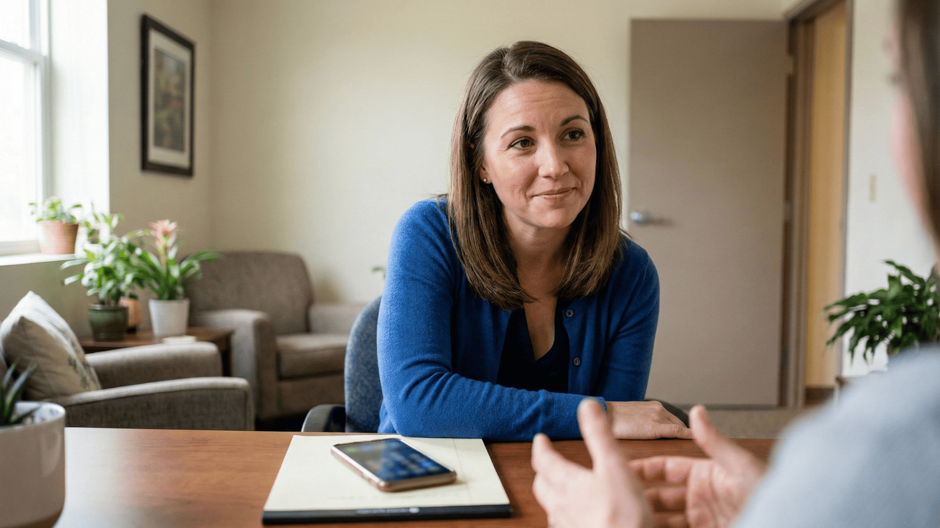 Patient meeting with pregnancy center staff in private counseling room