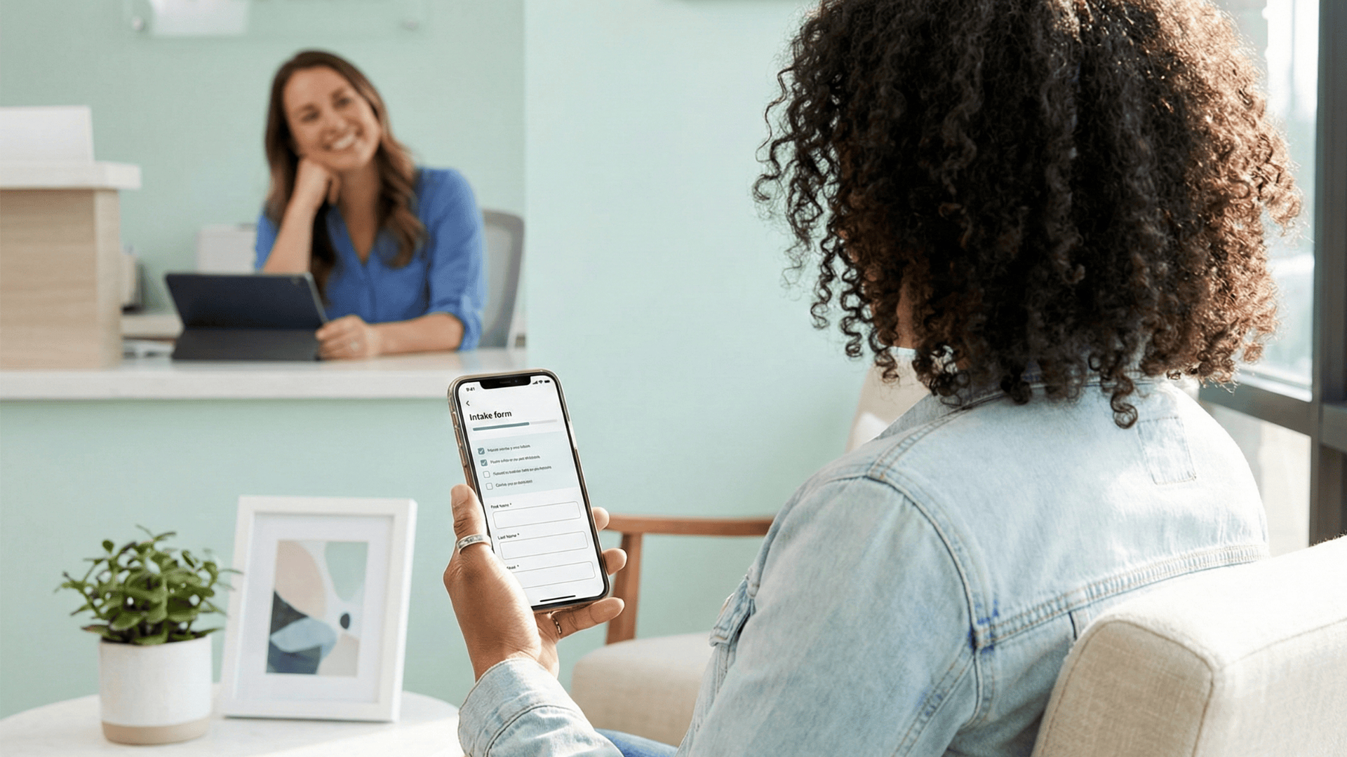 Patient completing digital intake form on phone in clinic waiting area