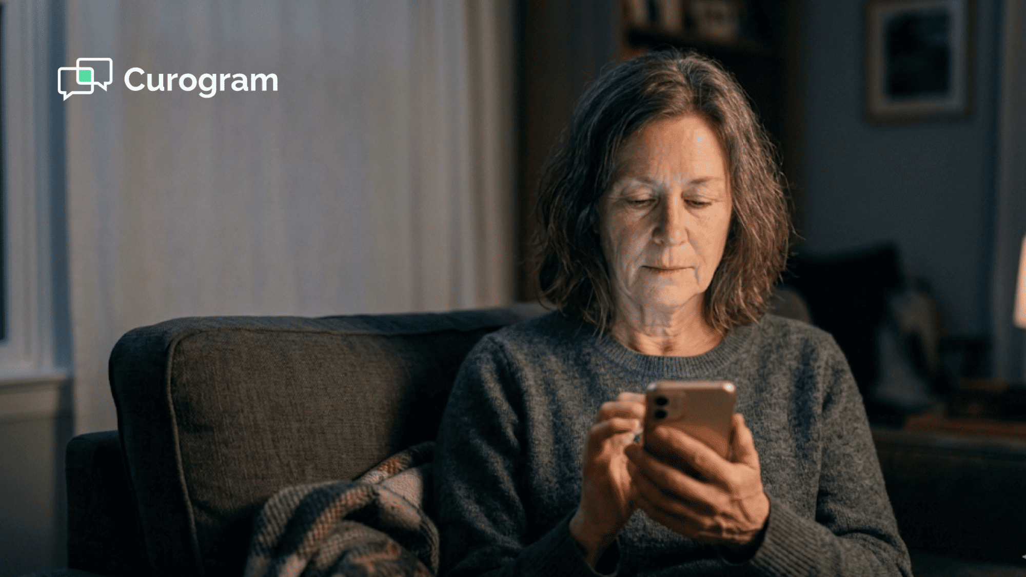 Person sitting alone at night lit by phone glow