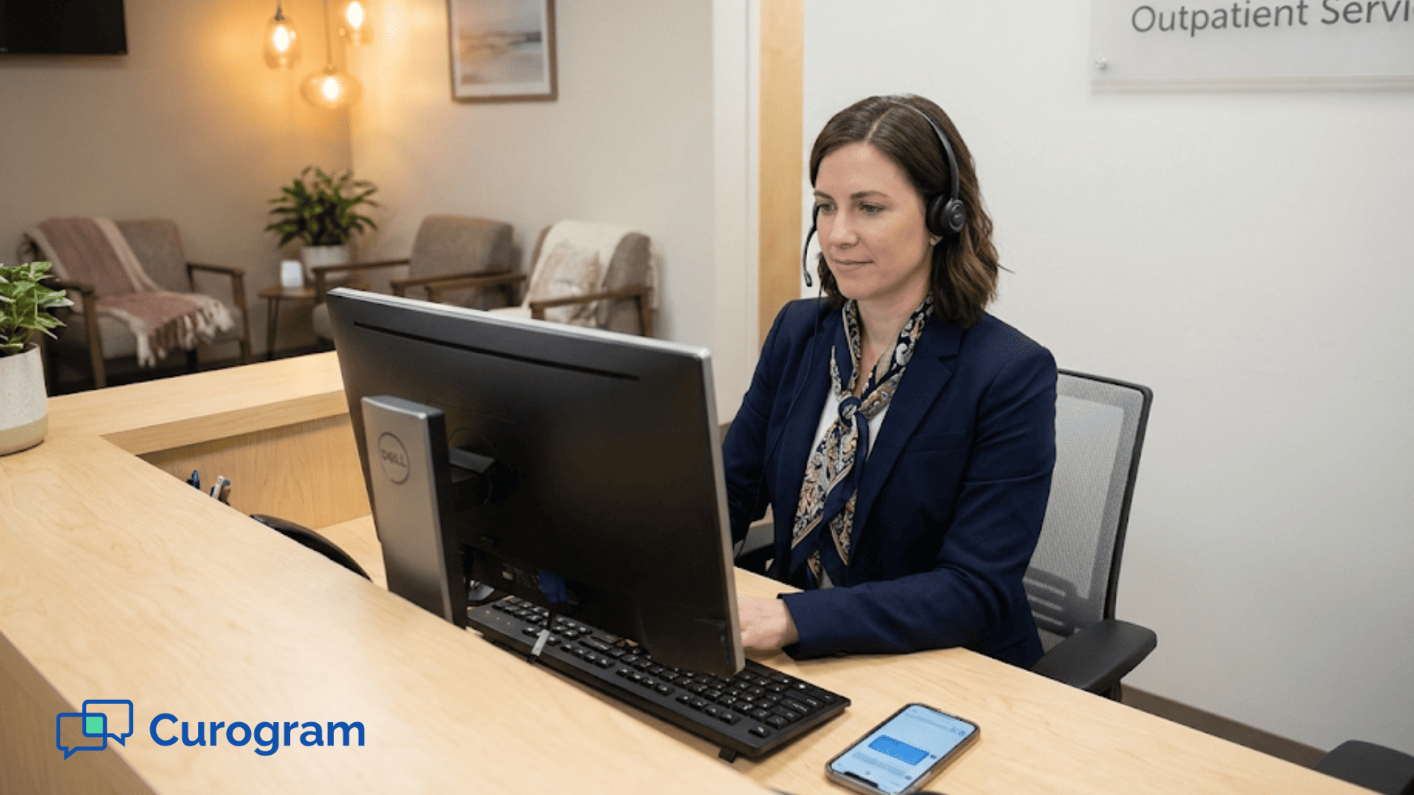 Behavioral health clinic staff member managing patient outreach from front desk computer