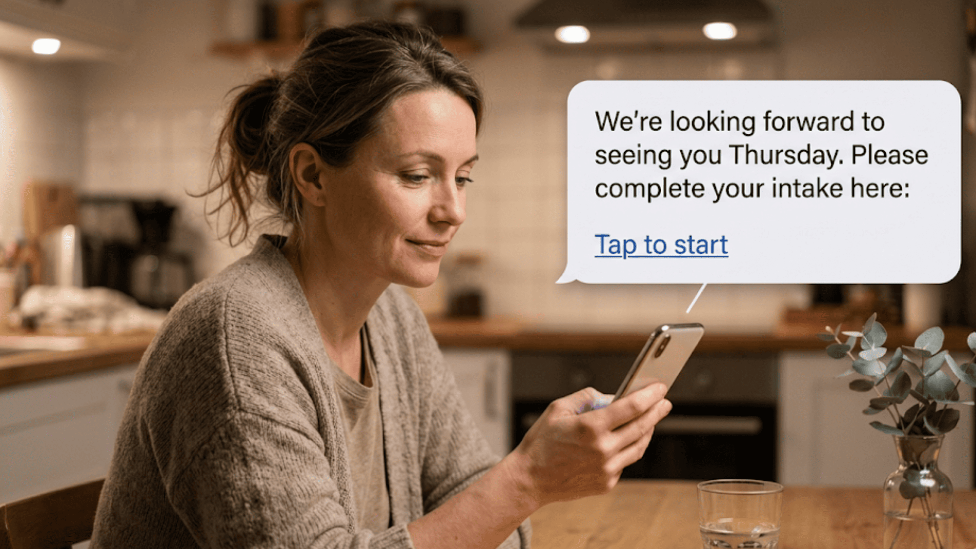 Woman reading a friendly pre-appointment text invitation to complete patient-friendly intake forms on her smartphone