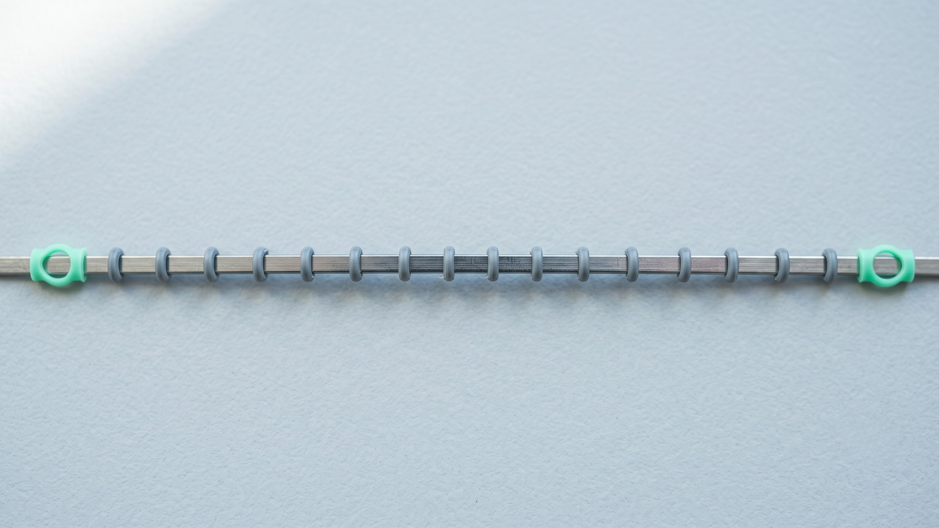 Orthodontic archwire laid out as a timeline marking 18 months of adjustment visits