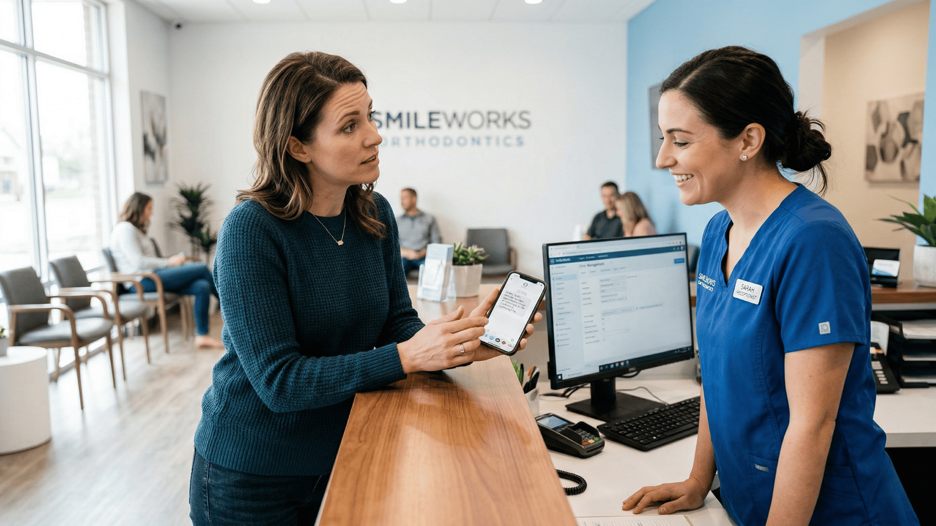 Parent showing text message to orthodontic front desk staff at reception