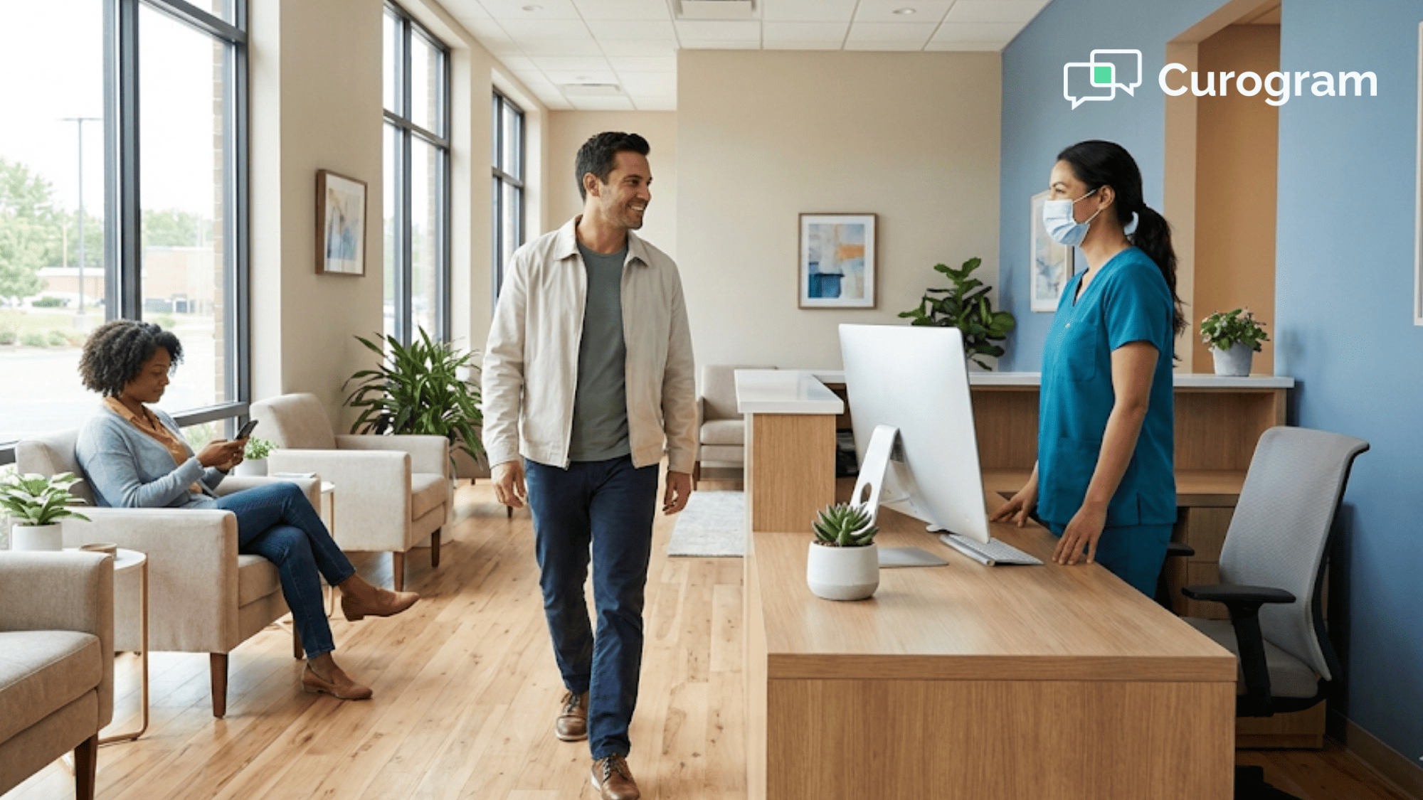 Front desk staff greeting a patient in a paperless clinic lobby with a clean tidy workspace