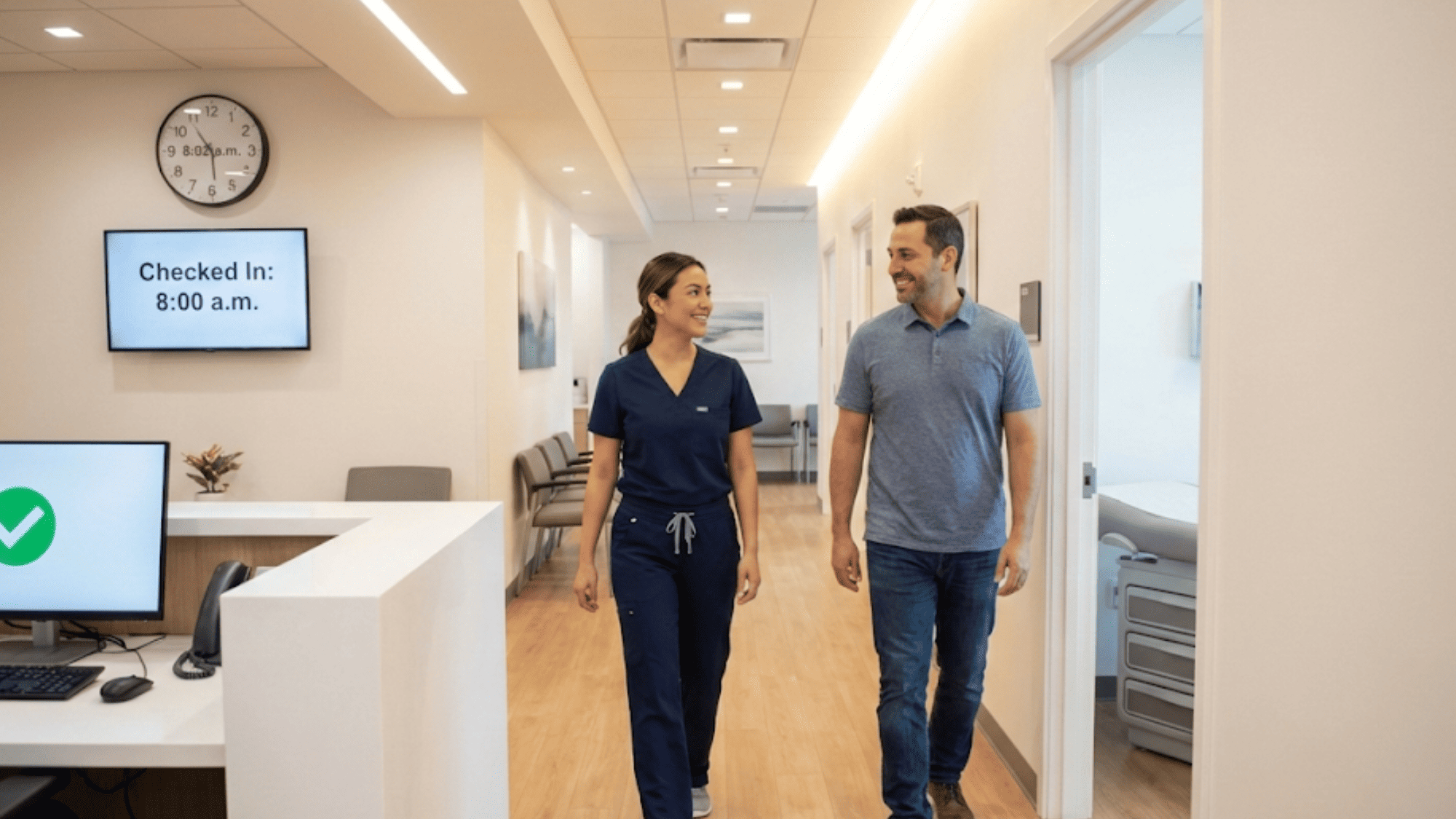 Medical assistant walking a patient to the exam room two minutes after check-in at a paperless clinic
