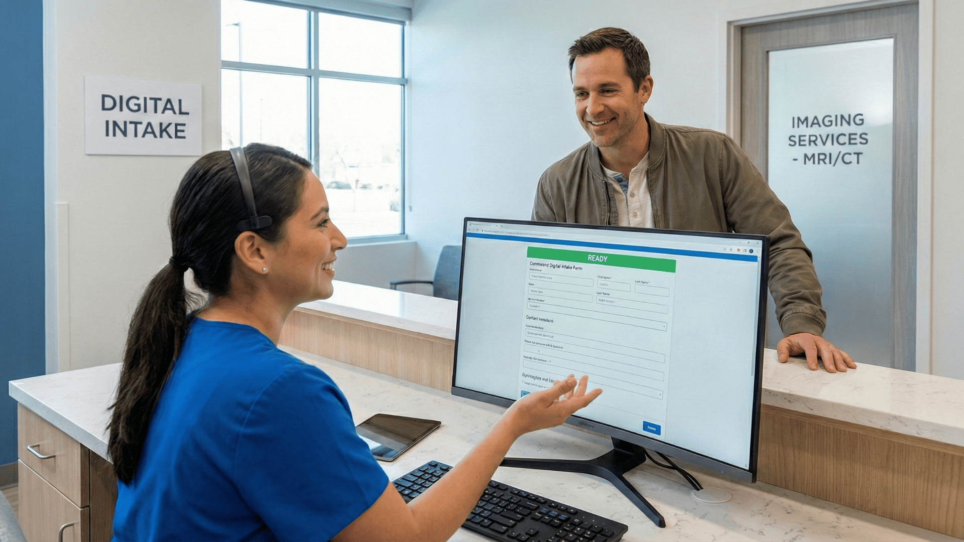 Imaging center staff reviewing completed digital intake with patient at check-in