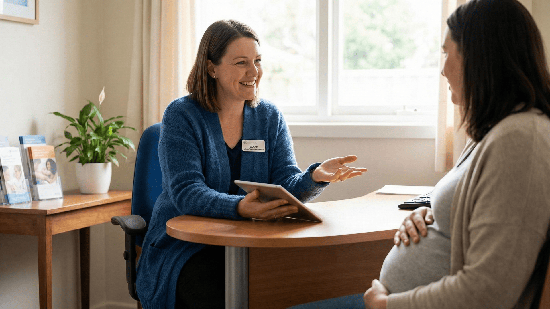 Patient receiving support from pregnancy center staff, professional setting