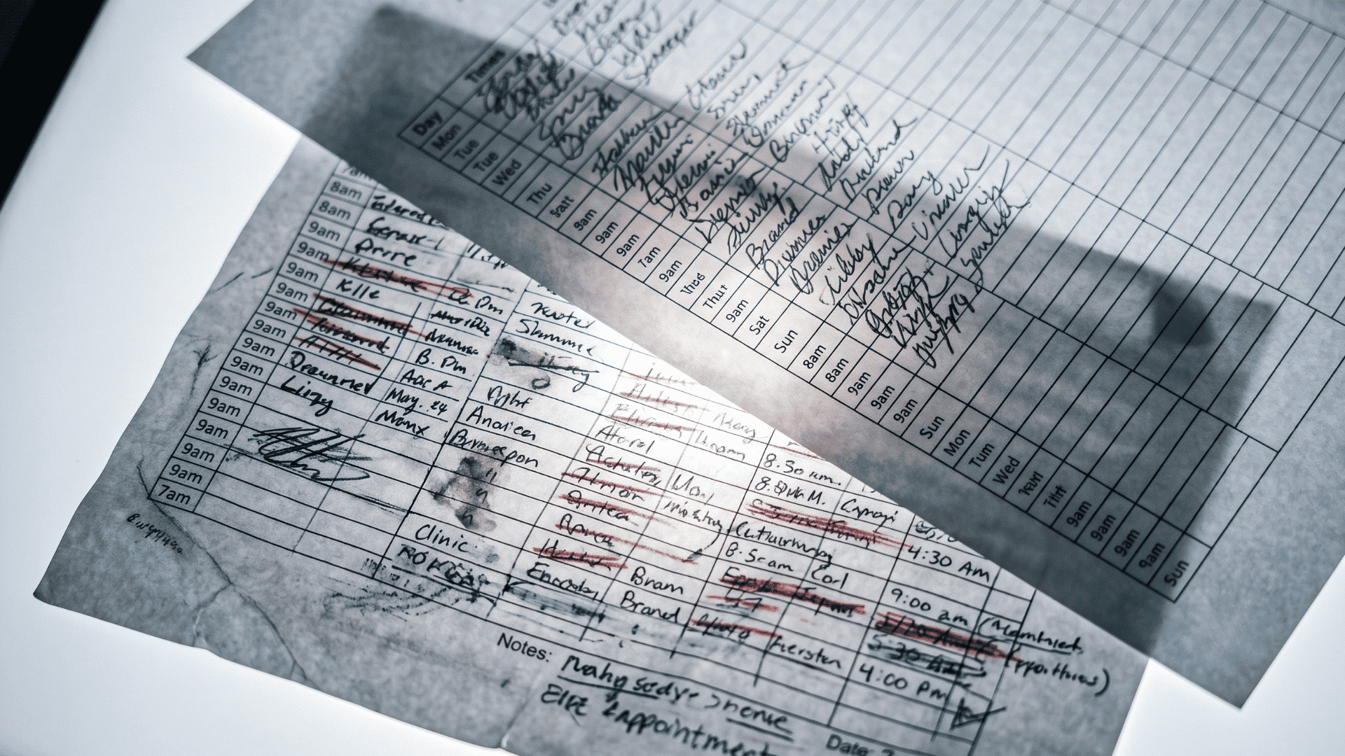 Backlit clinic schedules compared side by side, one marked with no-shows, one clean