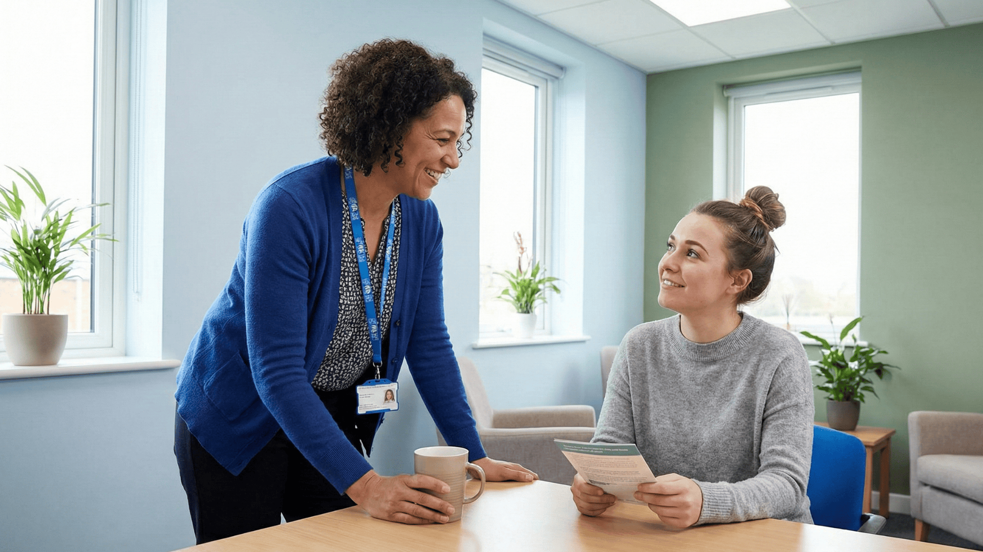 Pregnancy center staff member warmly speaking with a patient during a supportive visit