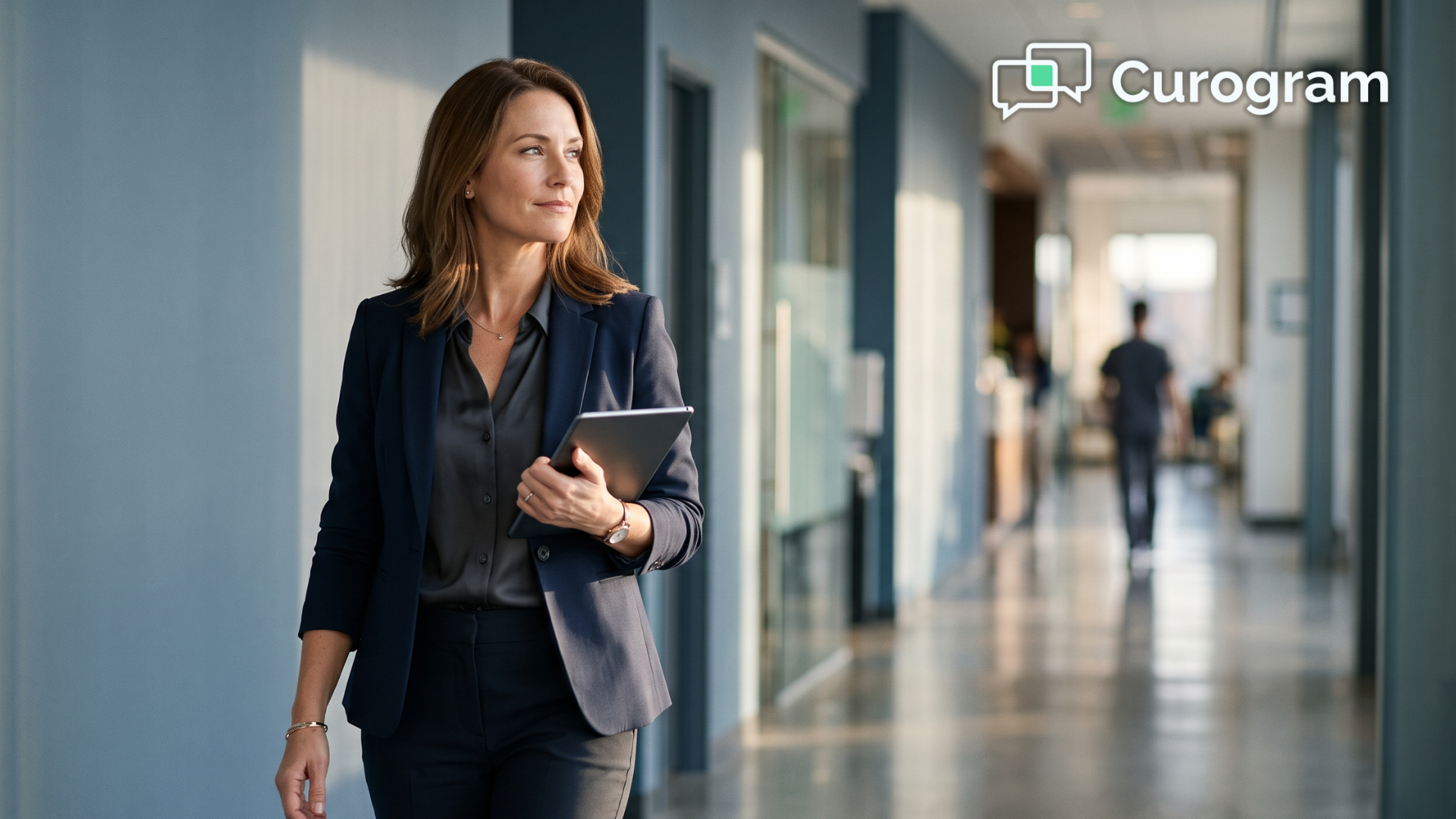 Practice manager reviewing automated patient text workflows in a bright clinic hallway