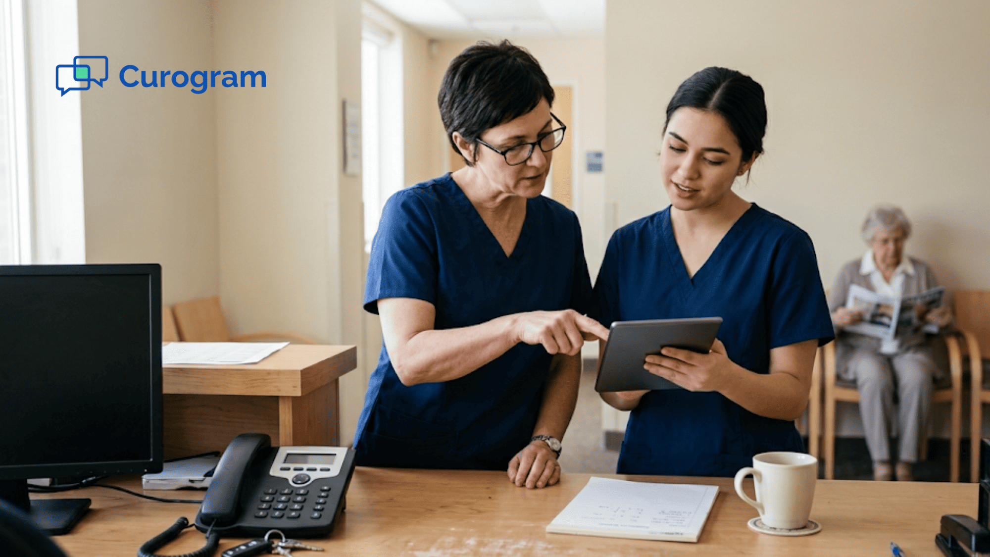 Clinic office manager showing a coworker how to use a new patient communication tool