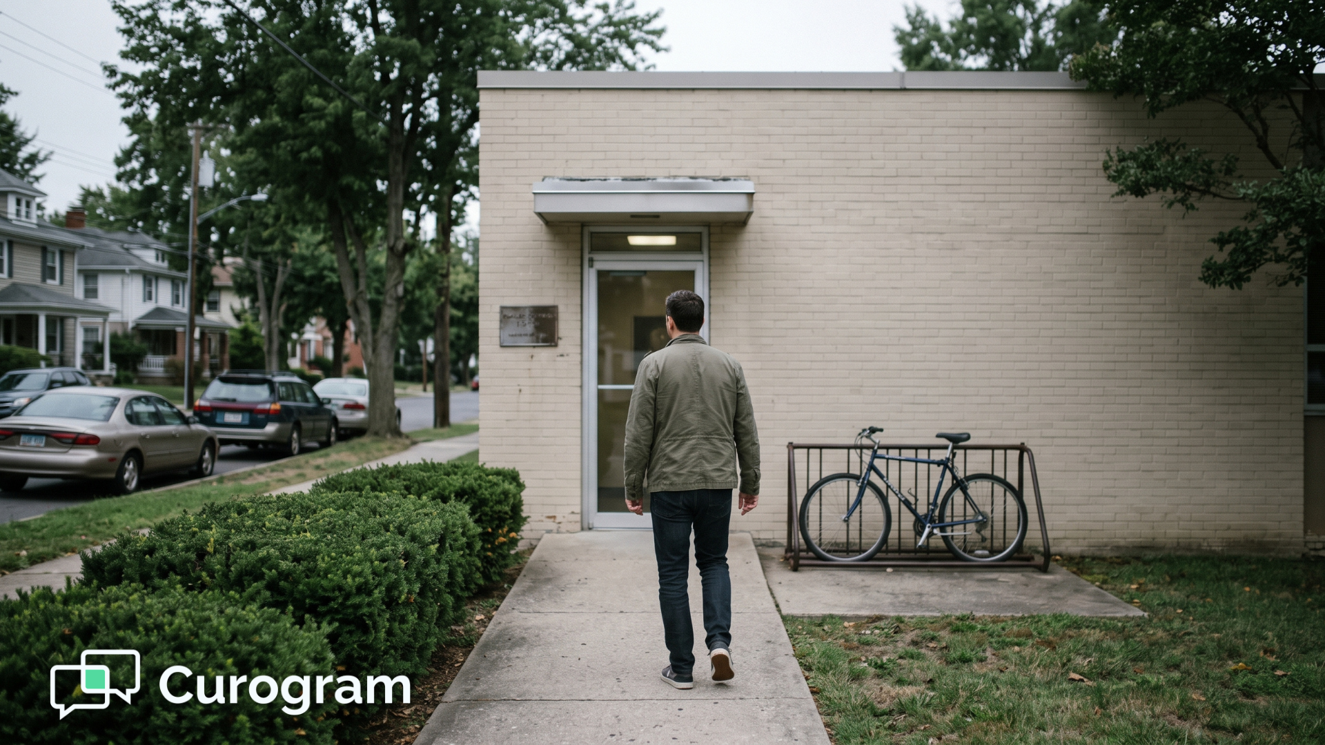 Person walking toward the entrance of a small neighborhood behavioral health office