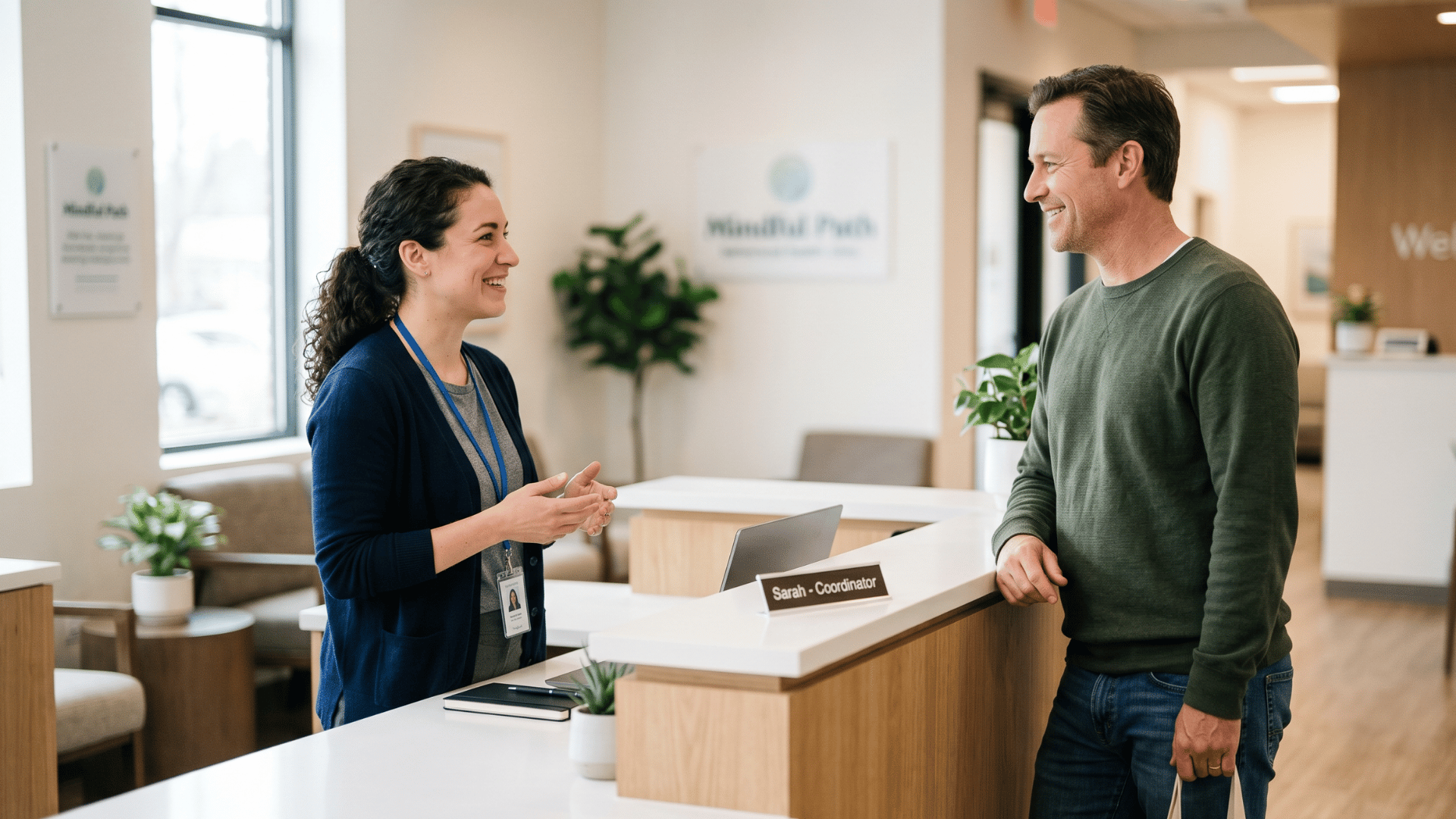 Behavioral health front desk coordinator helping a client at the check-in counter