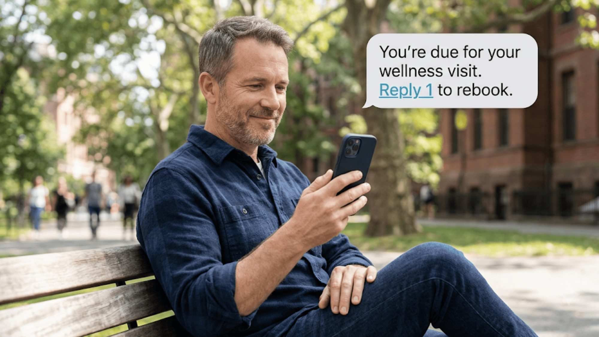 Man reading a recall text bubble prompting him to reply 1 and rebook his visit