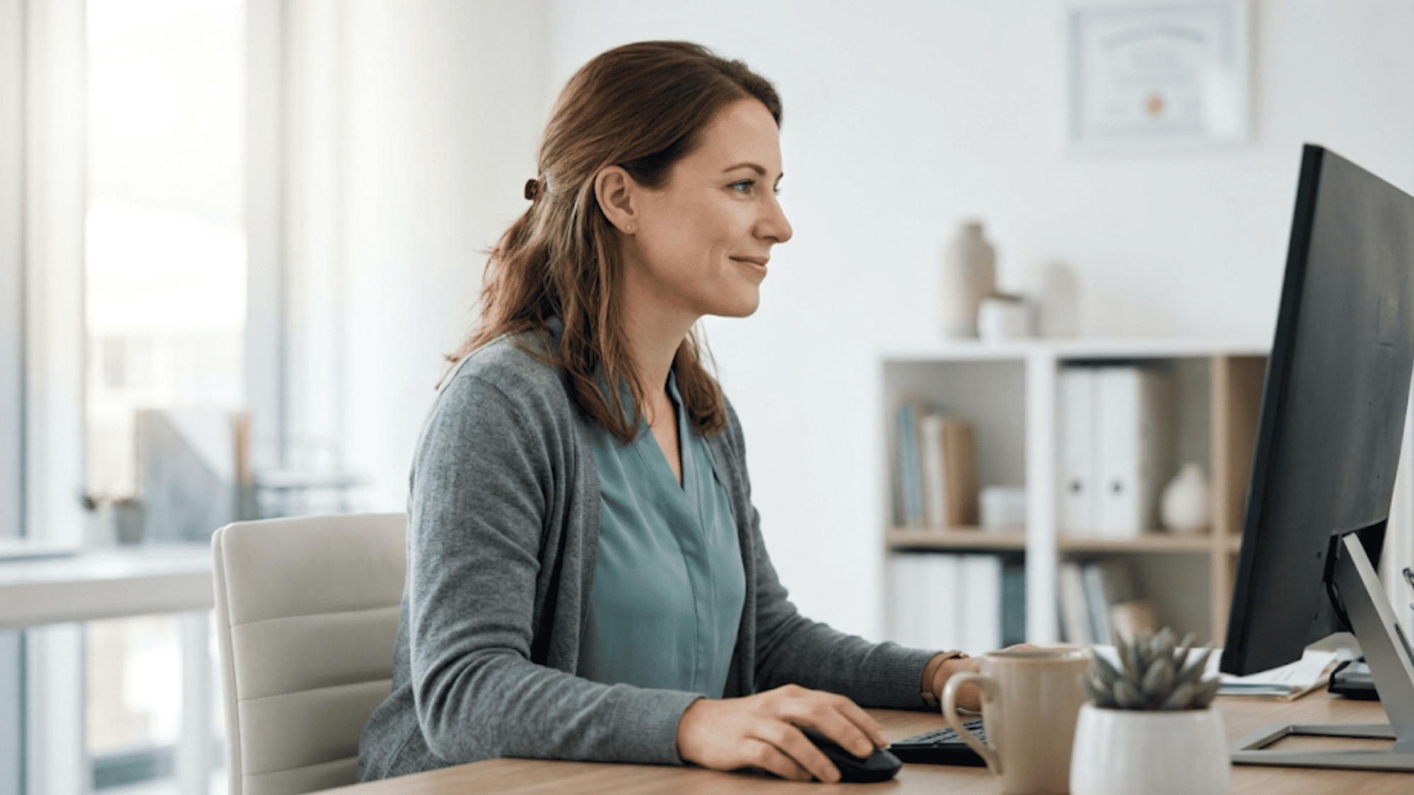 Practice manager calmly reviewing automated Google review dashboard results on her computer