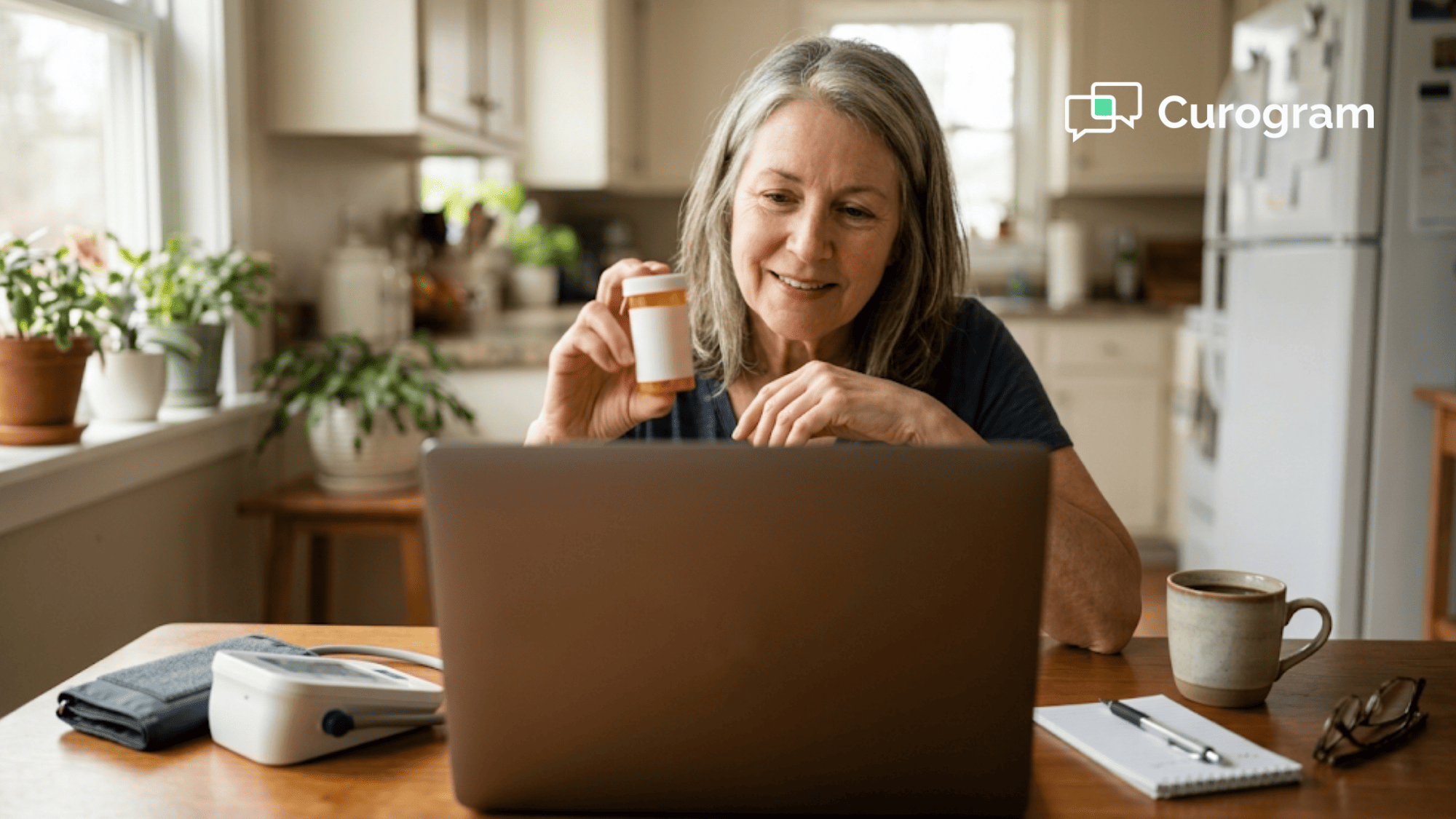 An older woman shows a pill bottle to her doctor during a telemedicine video visit at her kitchen table