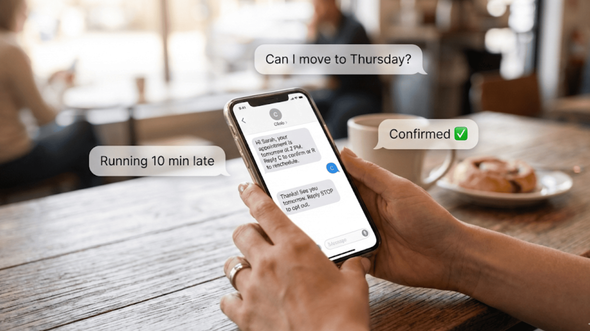 Patient hands holding smartphone displaying two-way text conversation confirming a medical appointment