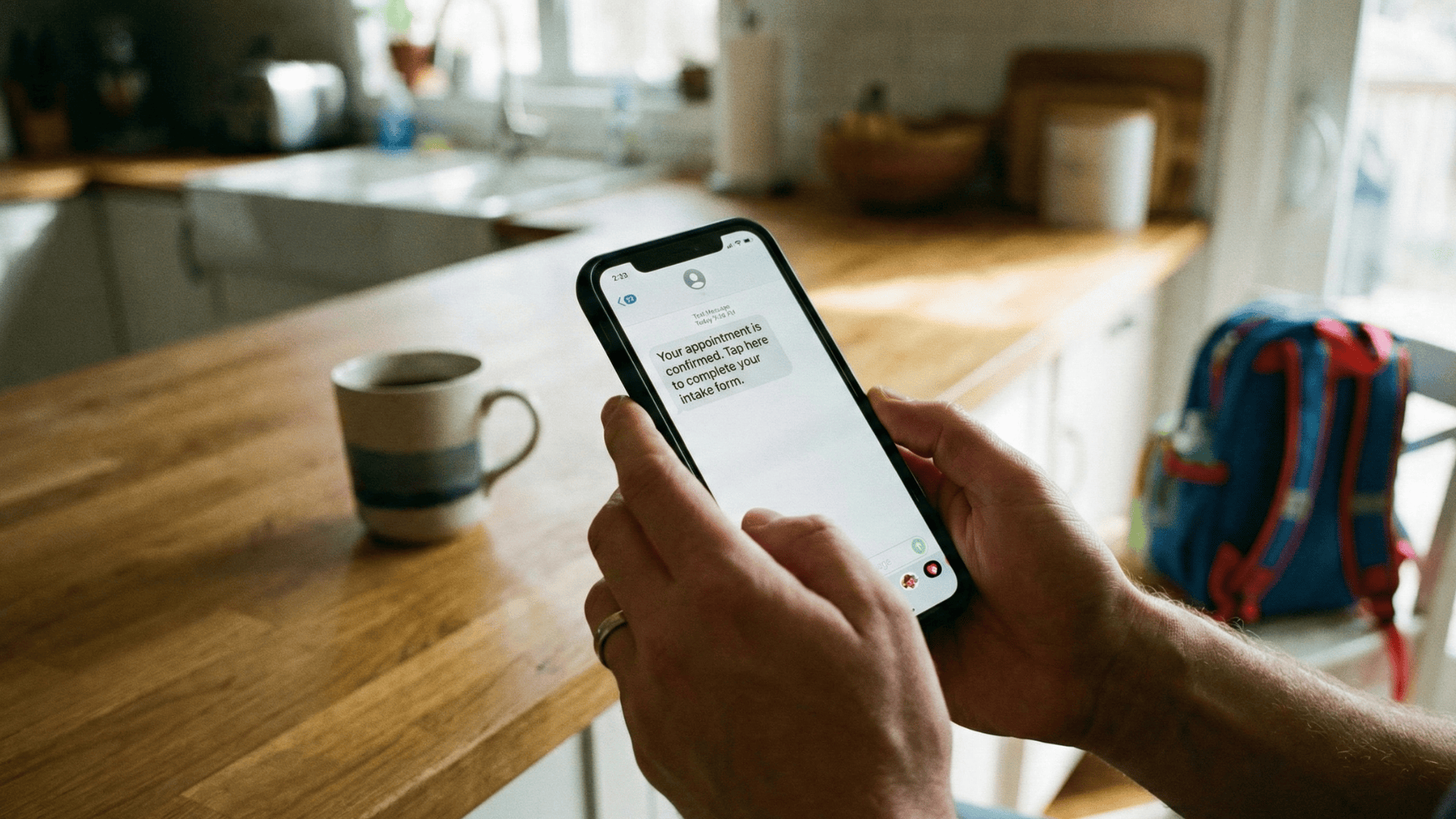 Patient confirming appointment via secure text message from home on smartphone