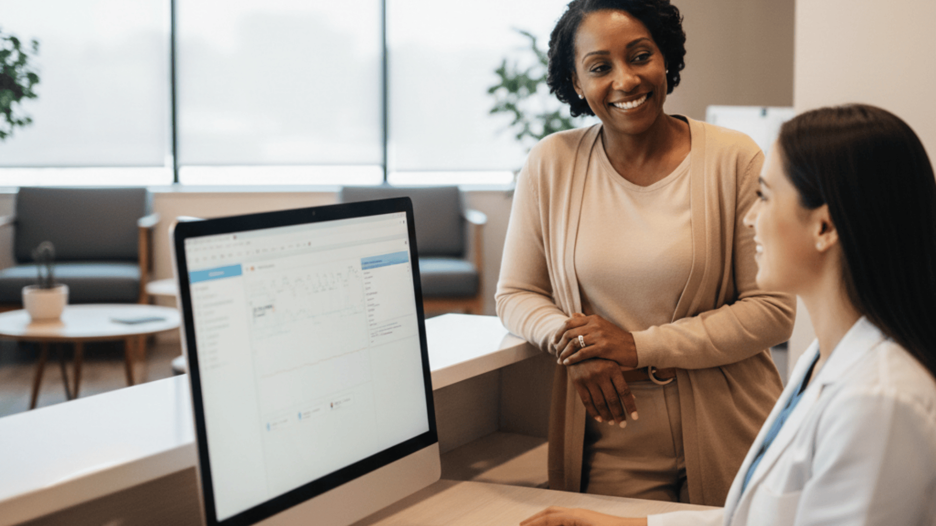 Medical receptionist and patient having friendly check-in conversation at organized desk