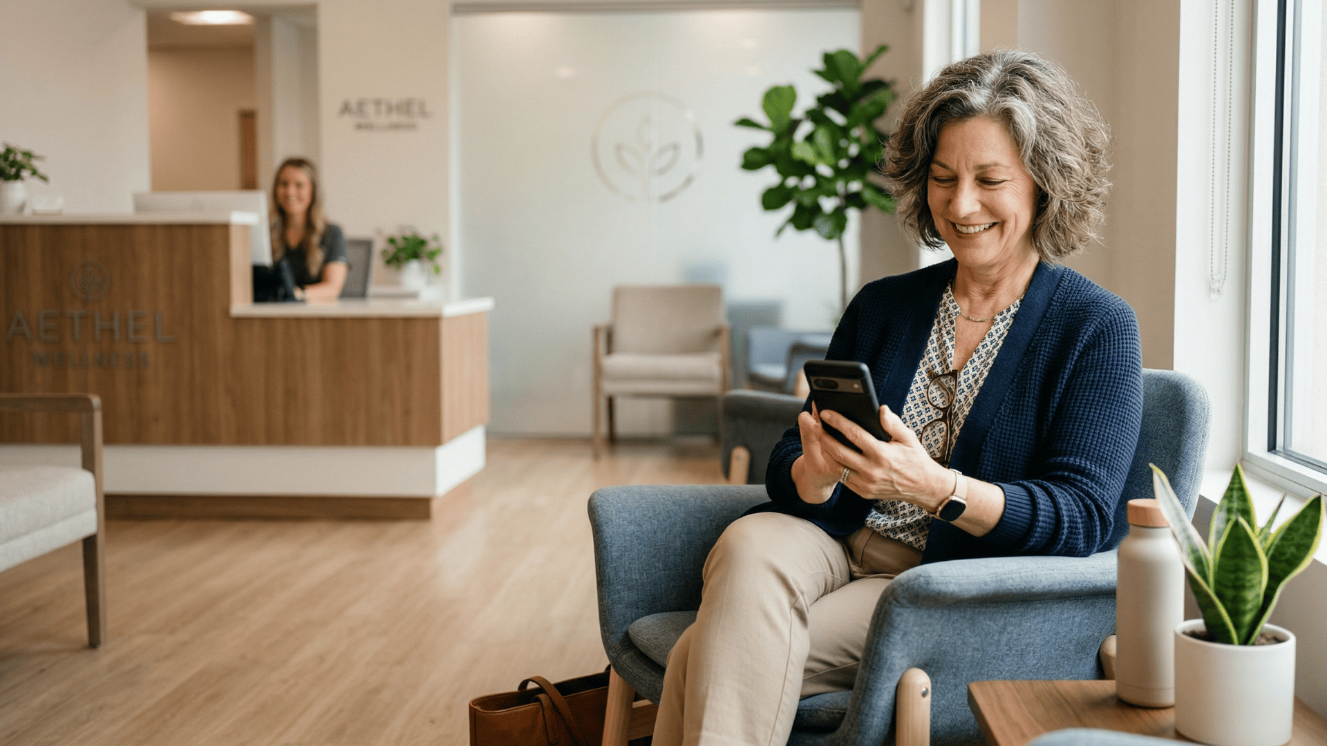 Patient reading appointment recall text message on smartphone in medical waiting area