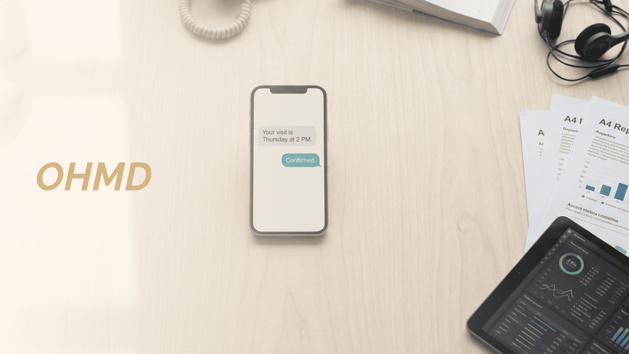 Minimalist desk scene showing one phone handling patient texting while bulky tools sit unused