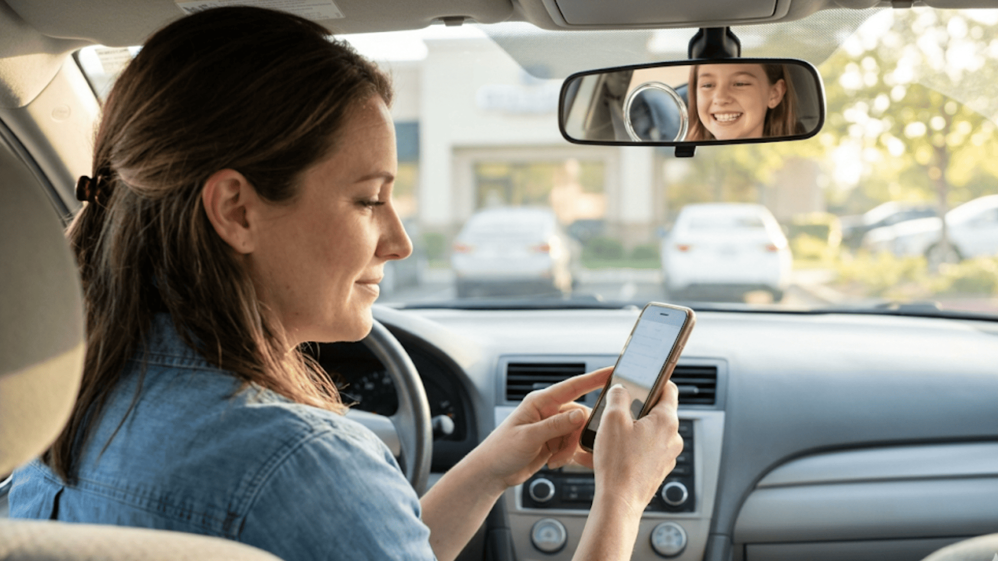 Parent taps her phone to leave a one-minute Google review for her Dolphin orthodontist while her daughter smiles nearby