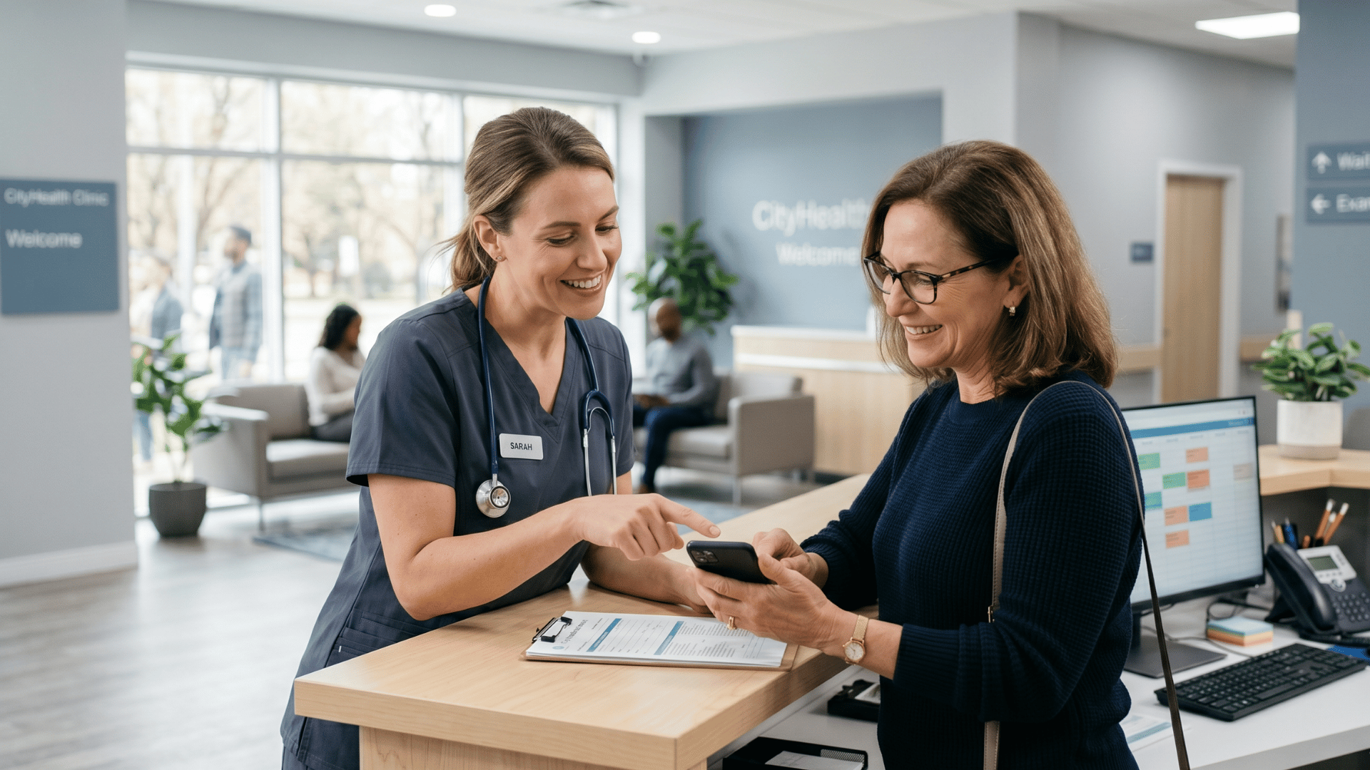 Clinic receptionist helping a patient use SMS payment link for healthcare billing at the front desk.