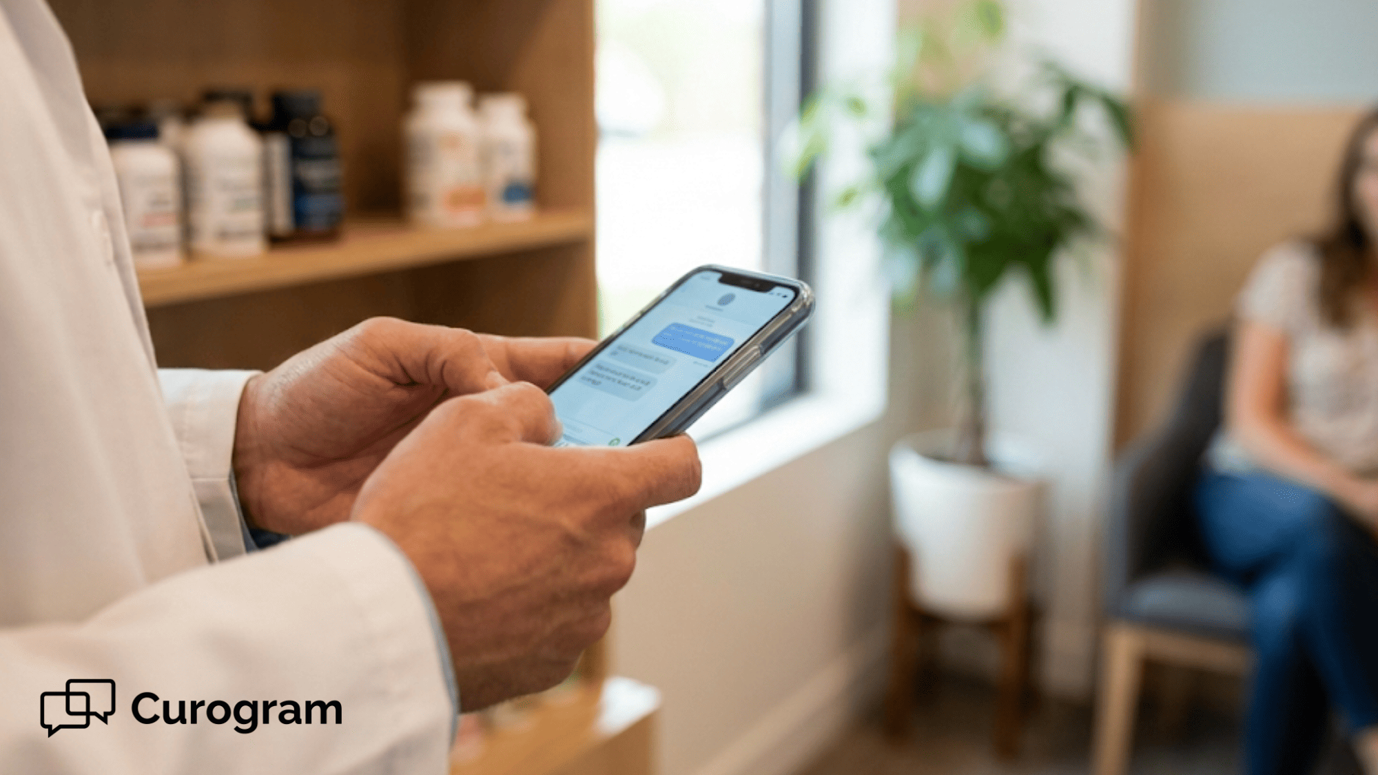 Healthcare provider holding smartphone with text messaging app in functional medicine clinic