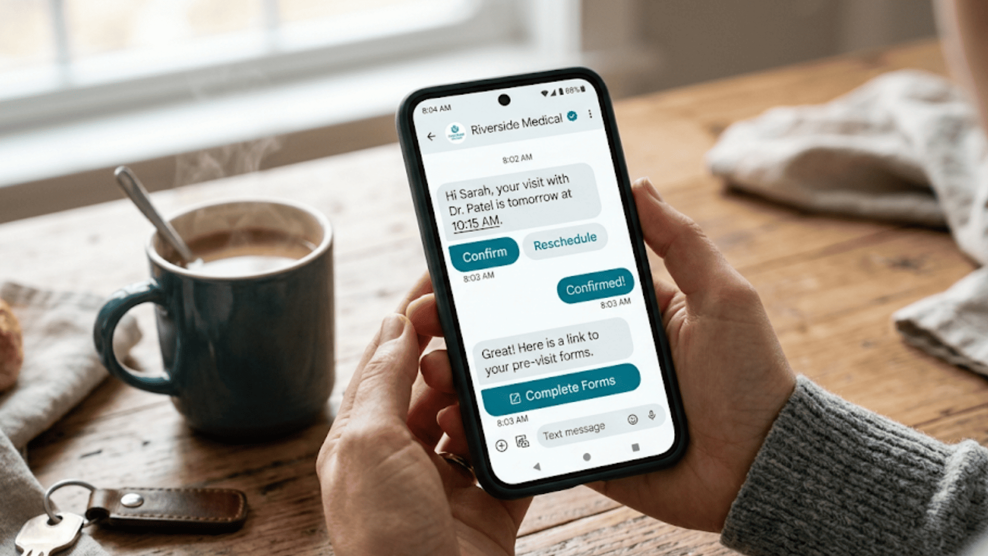 Patient confirming a doctor appointment through an interactive RCS text message on a smartphone at a kitchen table