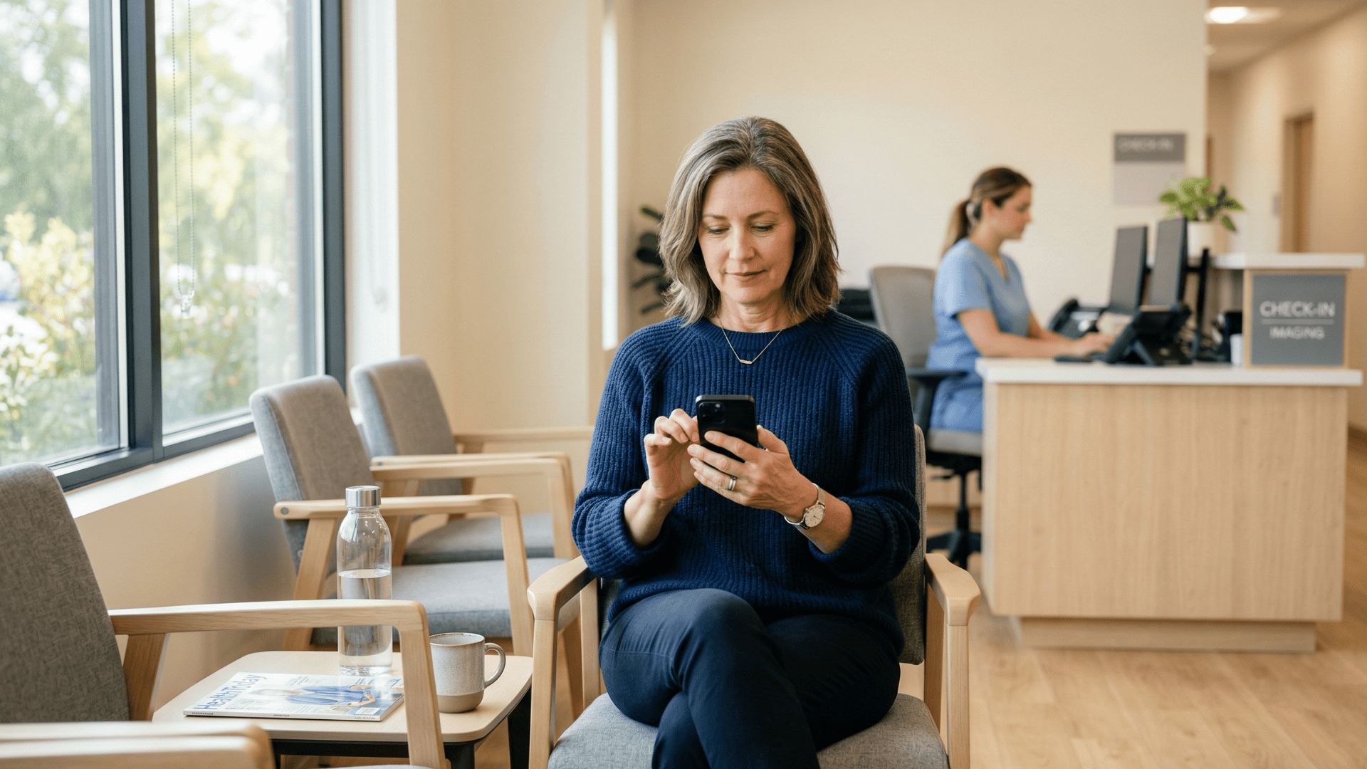 Patient reading automated prep reminder text in imaging center waiting room