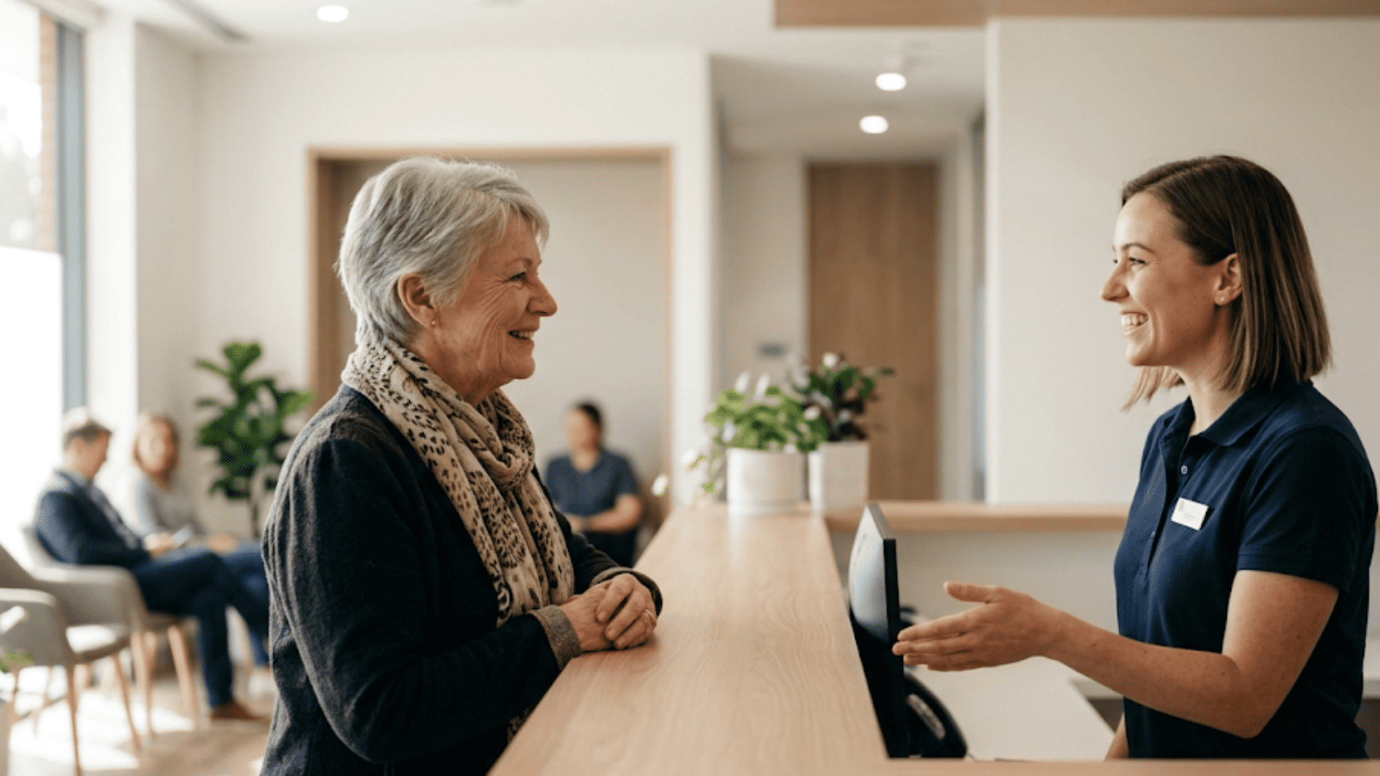 Lapsed patient returning to care, welcomed at a clinic front desk