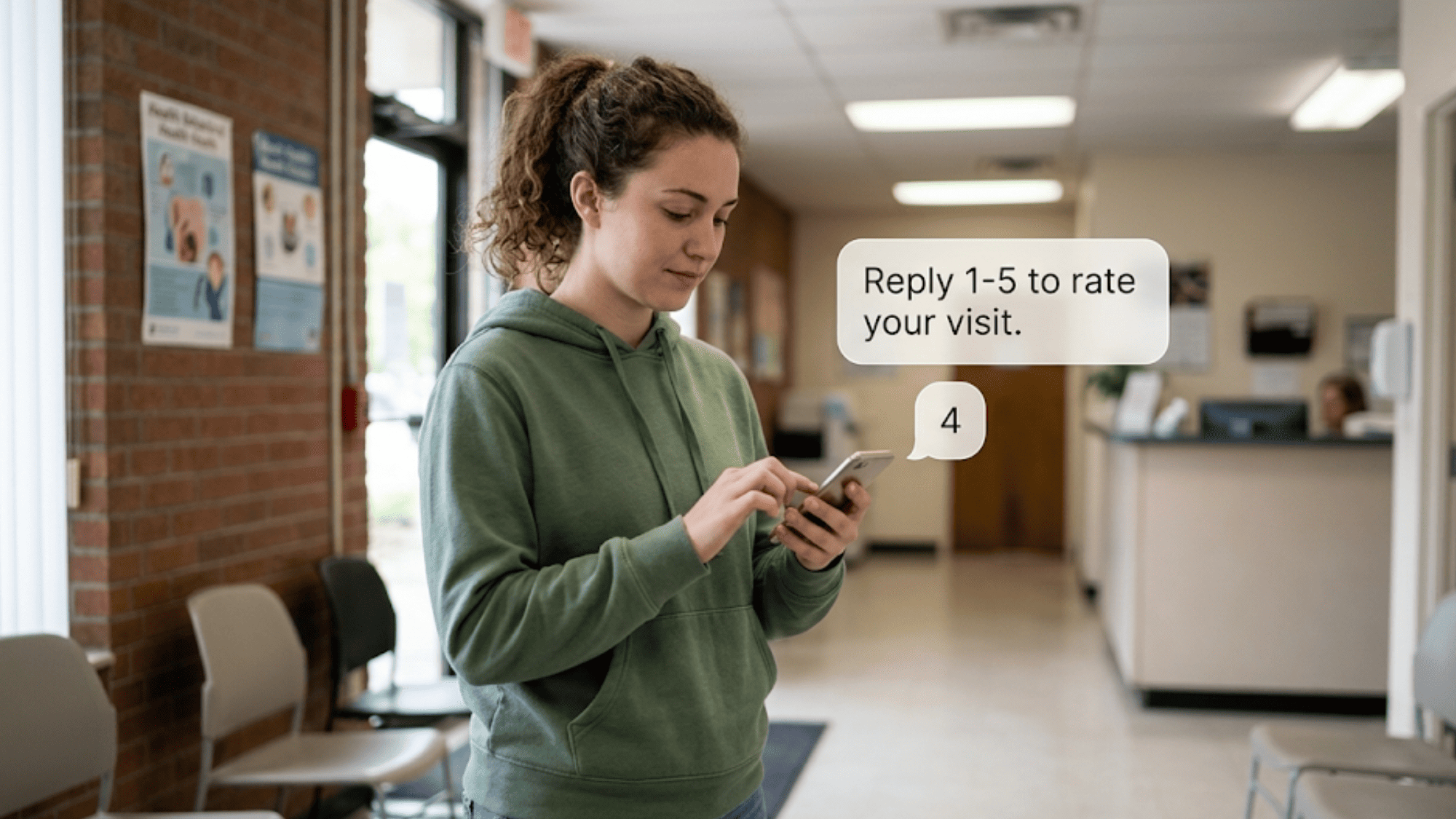 Young woman replying to SMS survey on her phone while leaving a community behavioral health clinic