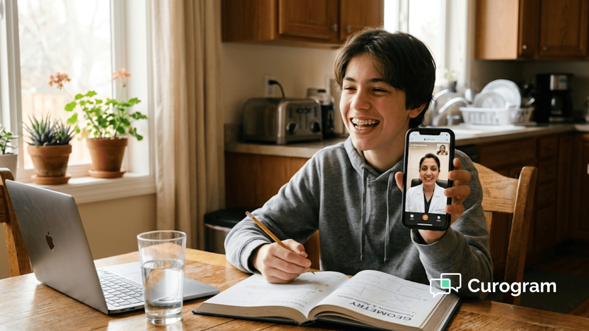 Teenage boy shows retainer to orthodontist during Dolphin virtual visit from kitchen table with geometry homework