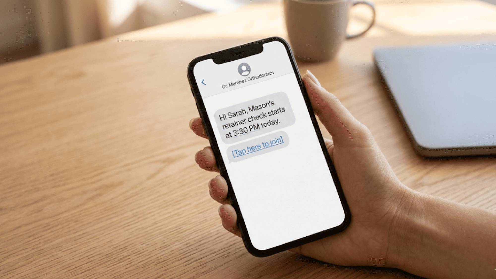Smartphone displaying text link from Dolphin orthodontist for one-tap video retainer check with no app needed