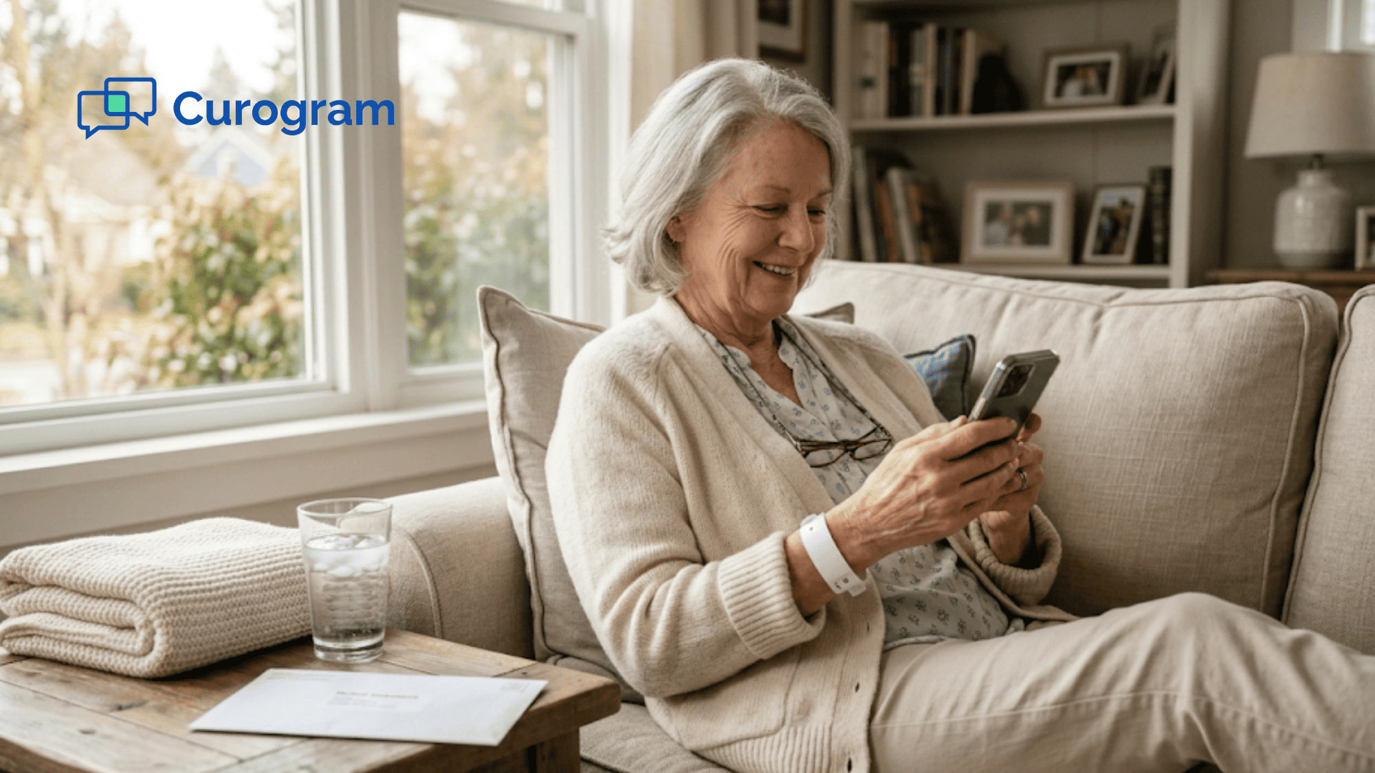 Senior patient sitting on couch using mobile payment text link after outpatient procedure