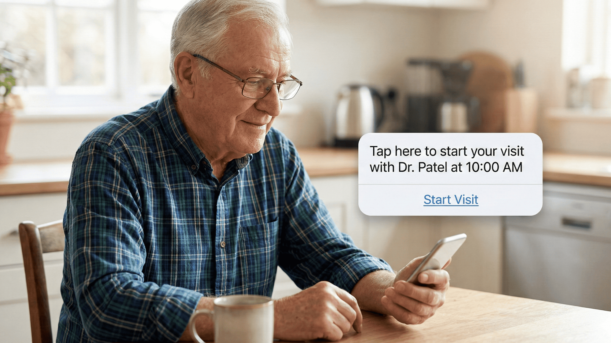 Senior man at his kitchen table reading a text message link to start a telemedicine video visit