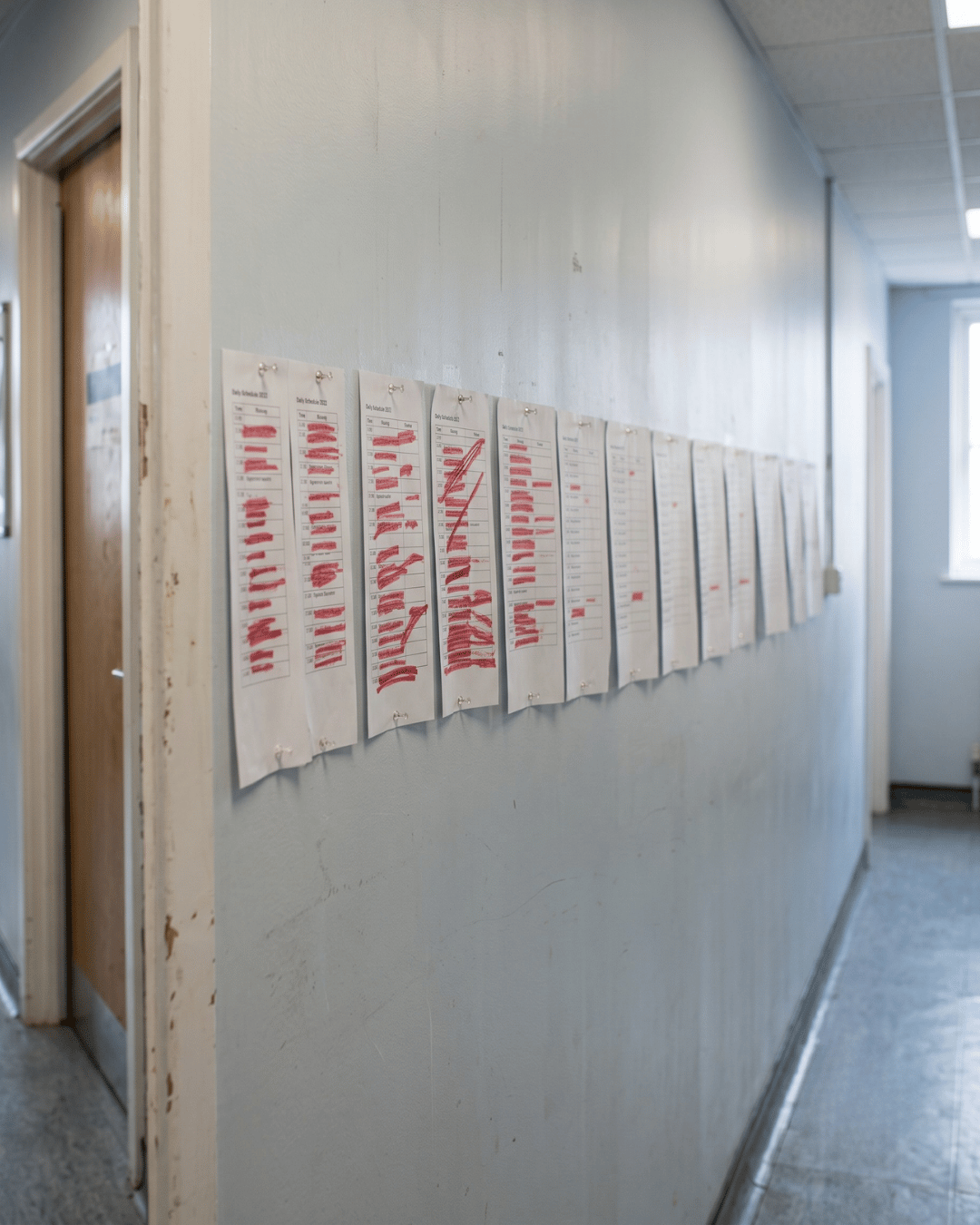 Weeks of clinic schedules on a wall showing the no-show rate dropping over time