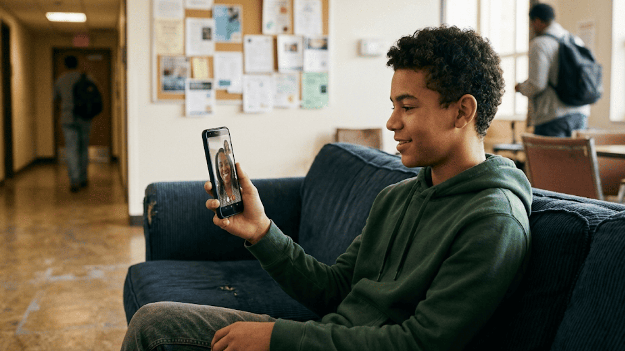 Young client in transitional housing on a candid virtual check-in call with his case manager using app-free video
