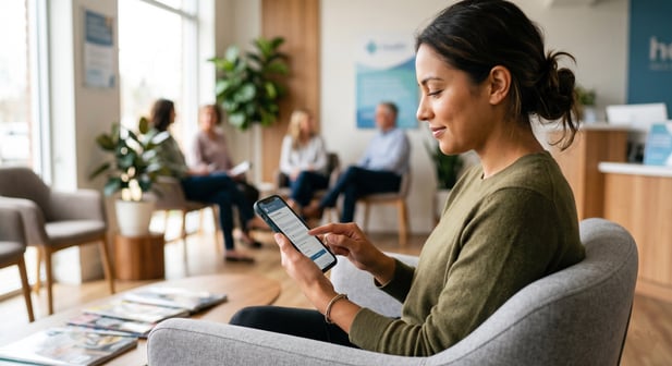 Patient in modern waiting room using a smartphone for digital registration
