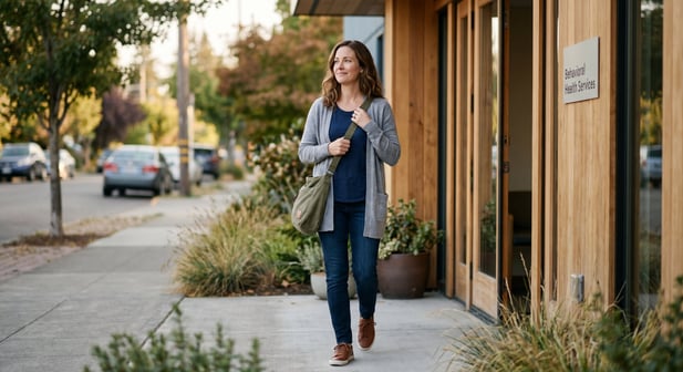 A happy, relaxed patient walking out of a modern Behavioral Health Services clinic
