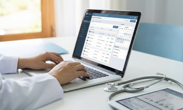Healthcare professionals collaborating on a digital virtual care workflow dashboard