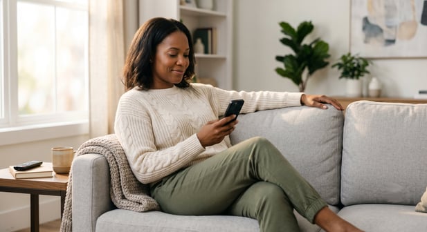 Relaxed patient completes behavioral health digital intake forms at home using her phone