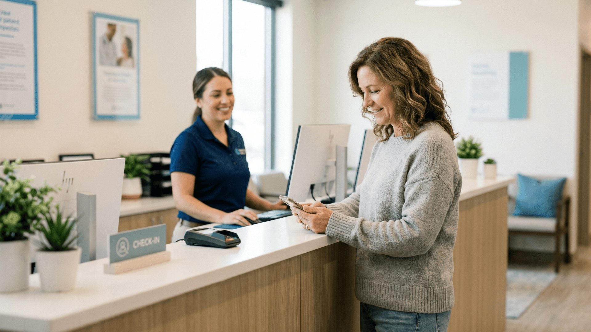 Patient receiving appointment confirmation text at a modern clinic front desk