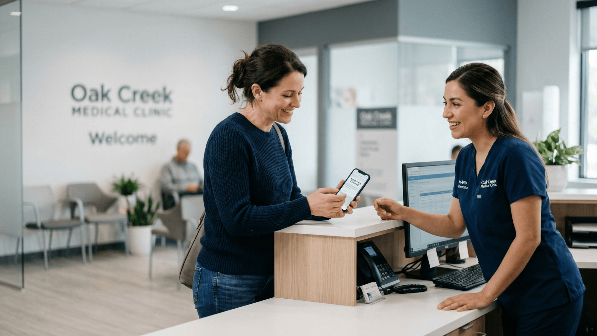 Patient receiving appointment confirmation text at a multi-location clinic front desk